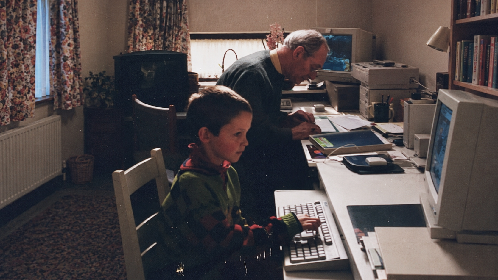 Ben as a child at a computer with his grandfather, with the image extended on both sides