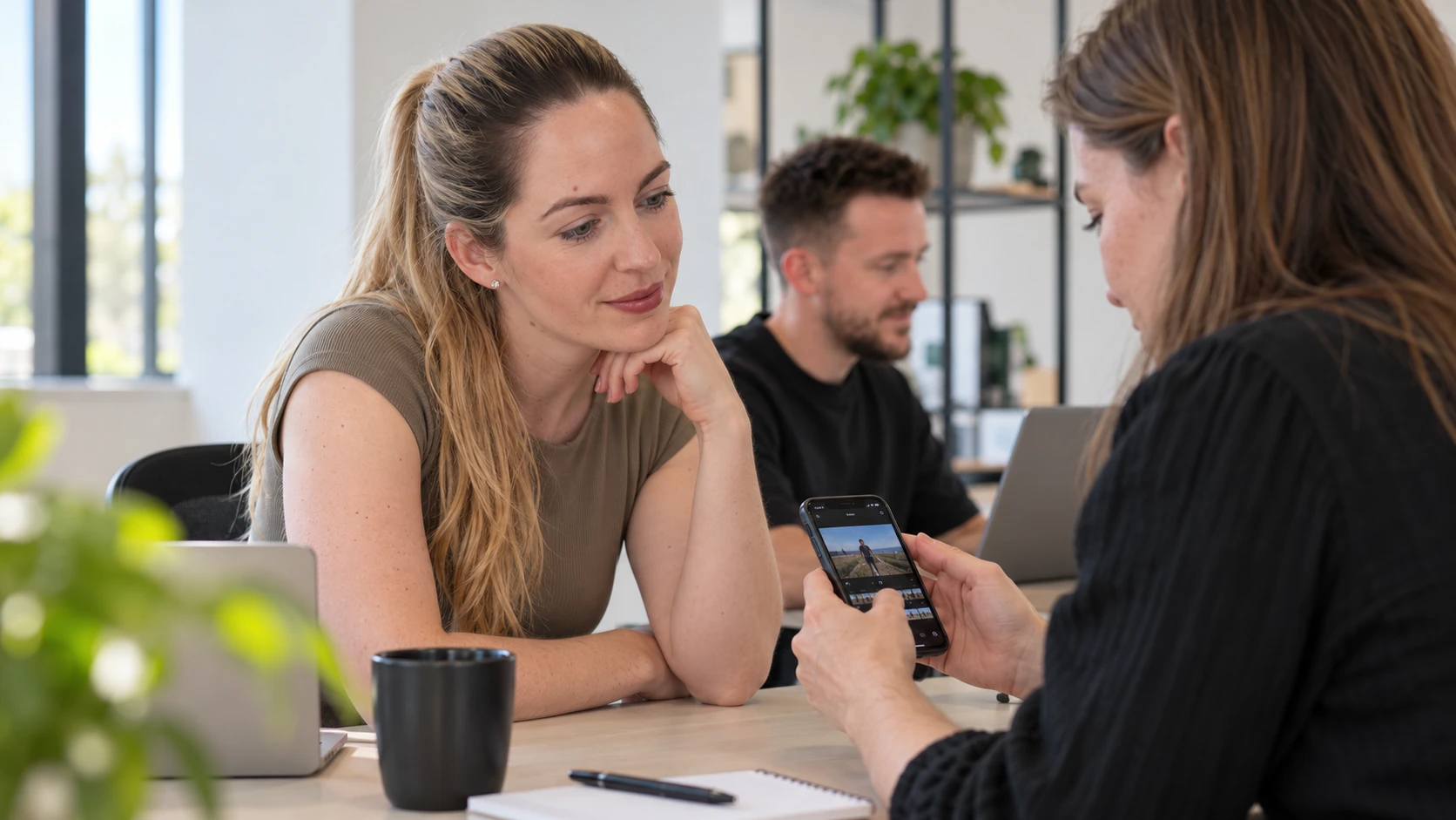 Sanne reviewing a mobile page with a colleague — generated visualisation